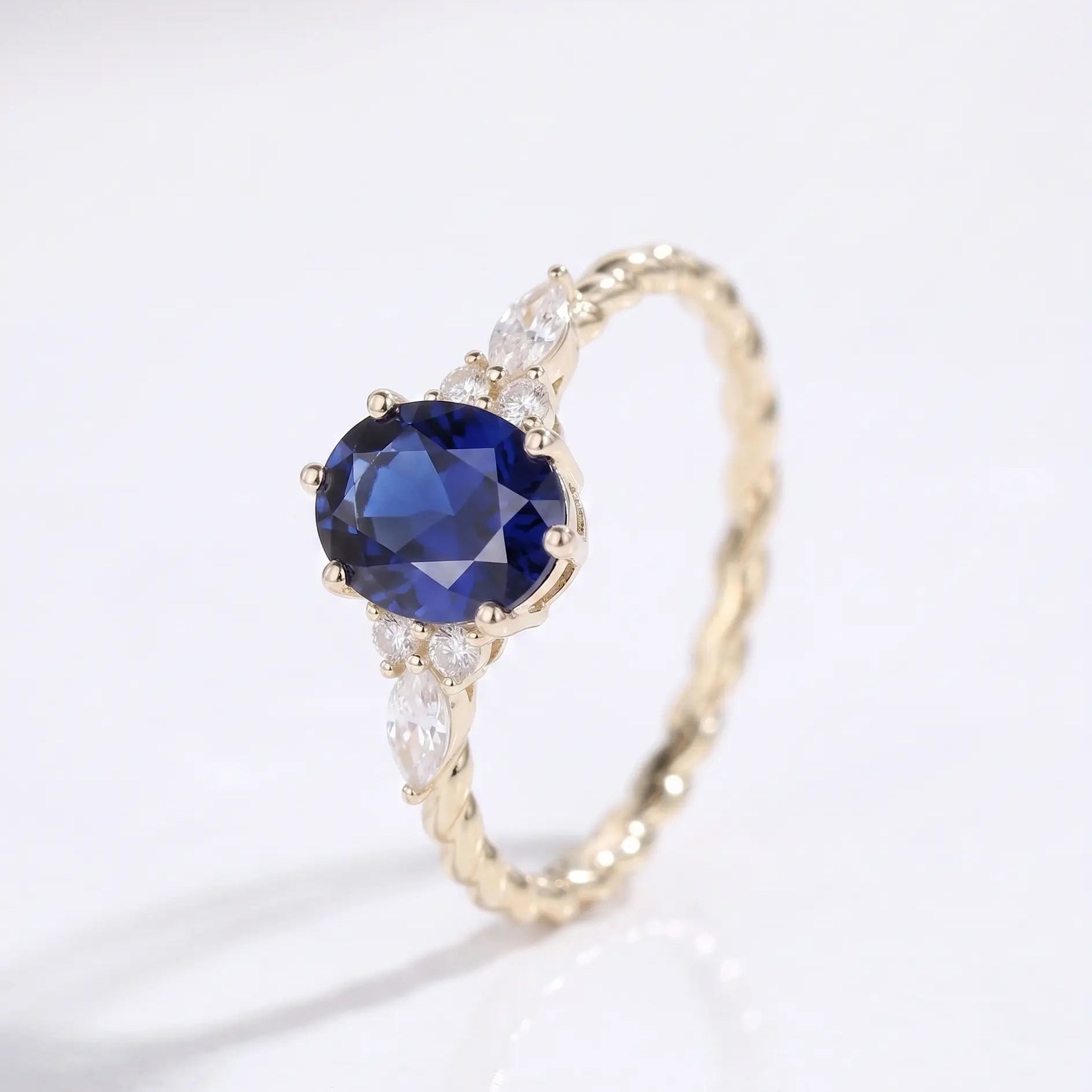 Oval Cut Blue Sapphire Ring with Marquise and Round Diamond Side Stones