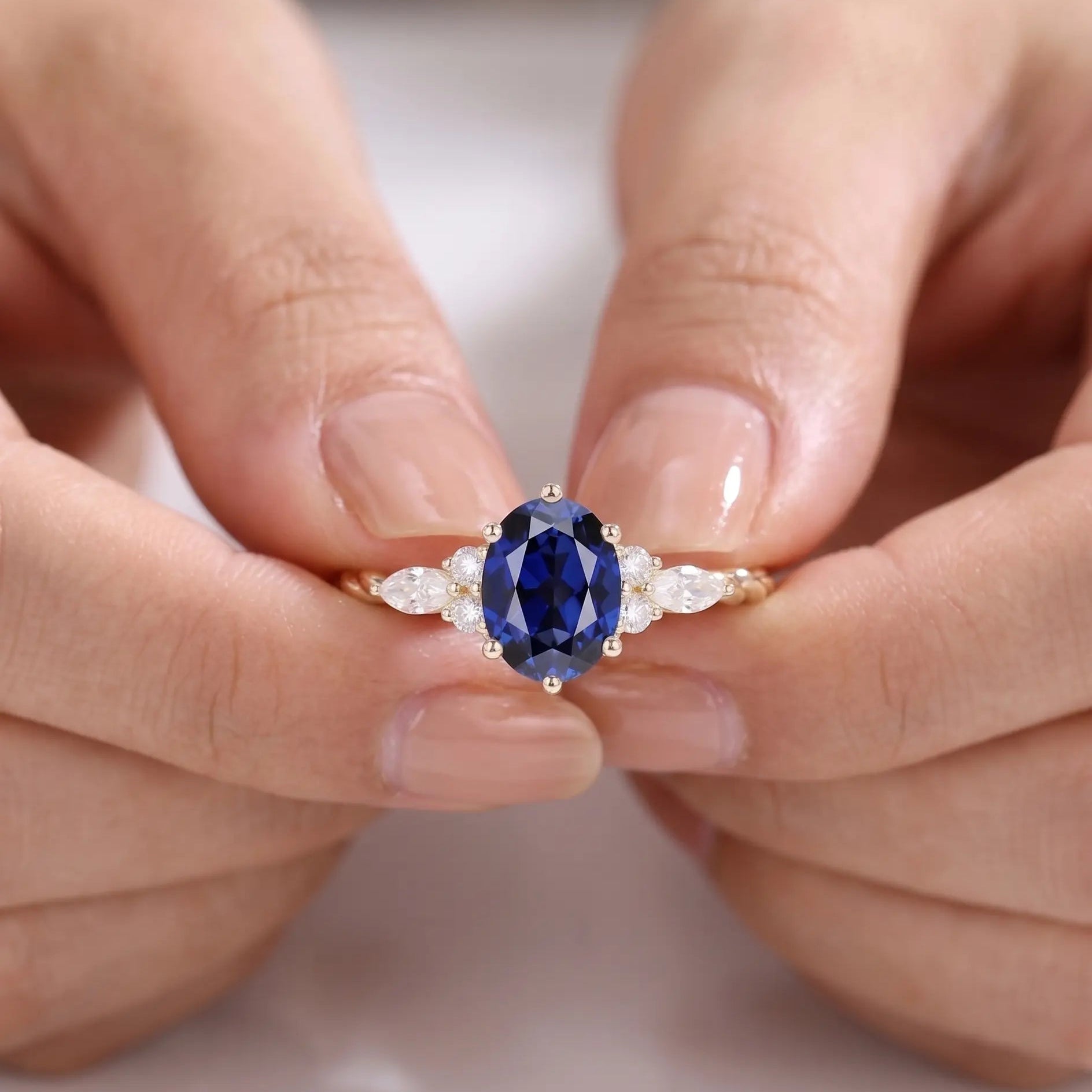 Oval Cut Blue Sapphire Ring with Marquise and Round Diamond Side Stones